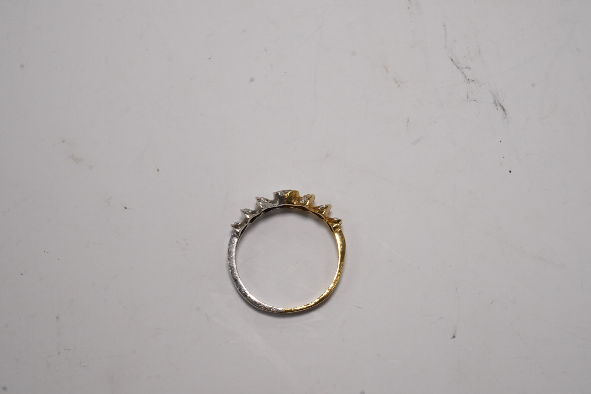 A yellow and white metal and seventeen stone diamond cluster set half hoop ring, size O/P, gross weight 3.3 grams. Condition - fair
